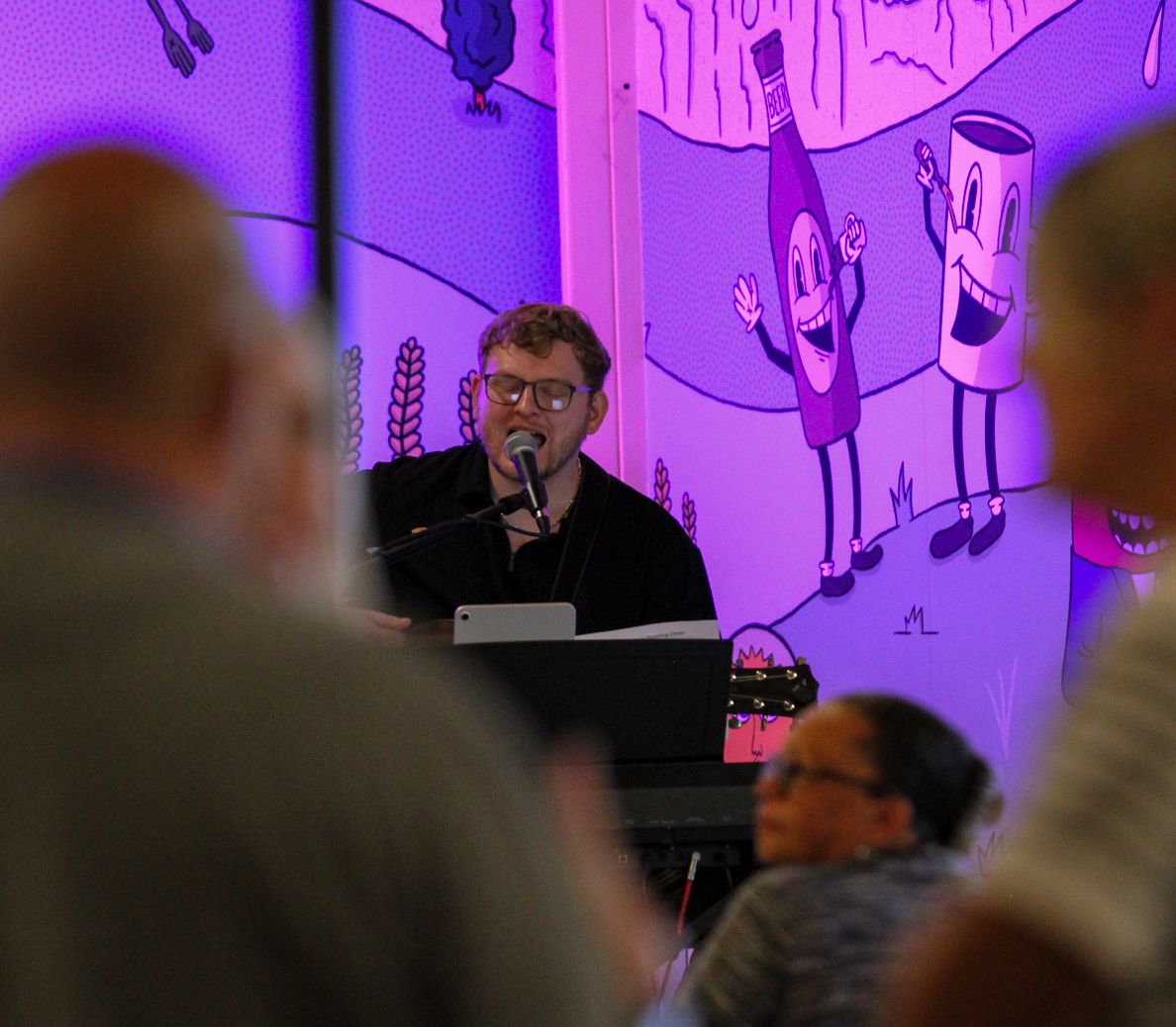 Jonathan Ruch singing at the keyboard during a live set