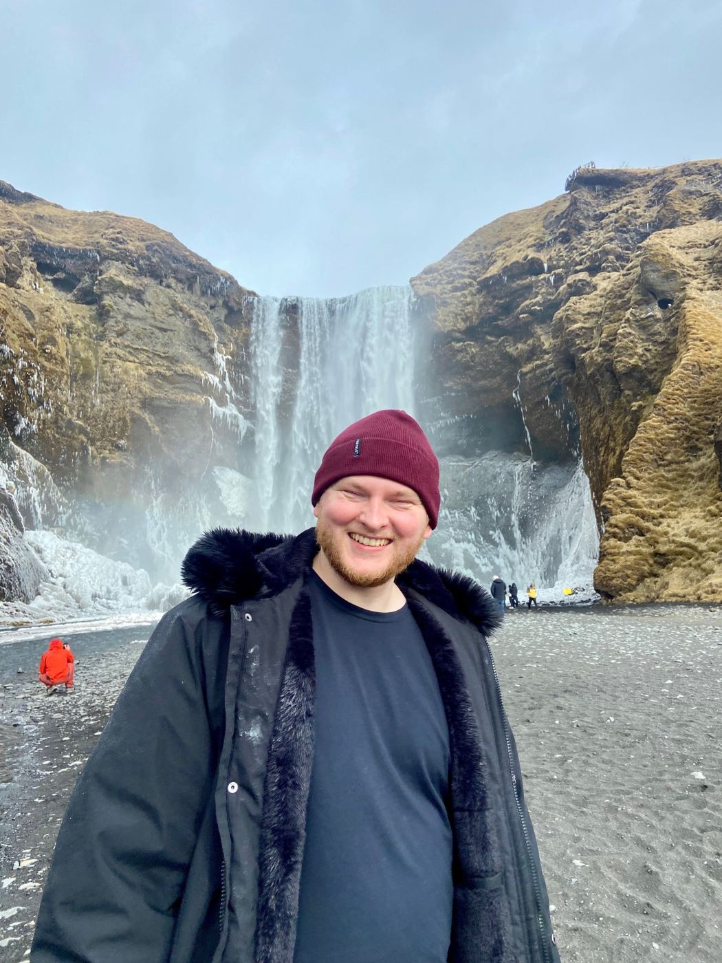 Jonathan Ruch smiling in front of a waterfall